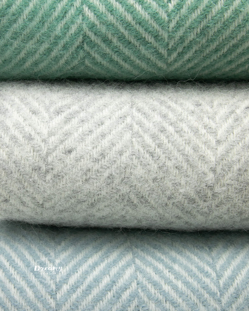 close up shot of wool blankets in teal green, grey, and soft blue hues  - dreamylondon