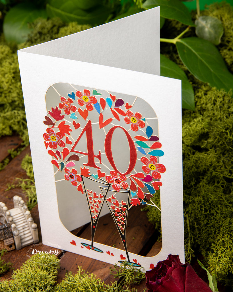 40th Wedding Anniversary Card - Ruby Wedding Anniversary Card that features clanking champagne glasses surrounded with hearts | Dreamy London