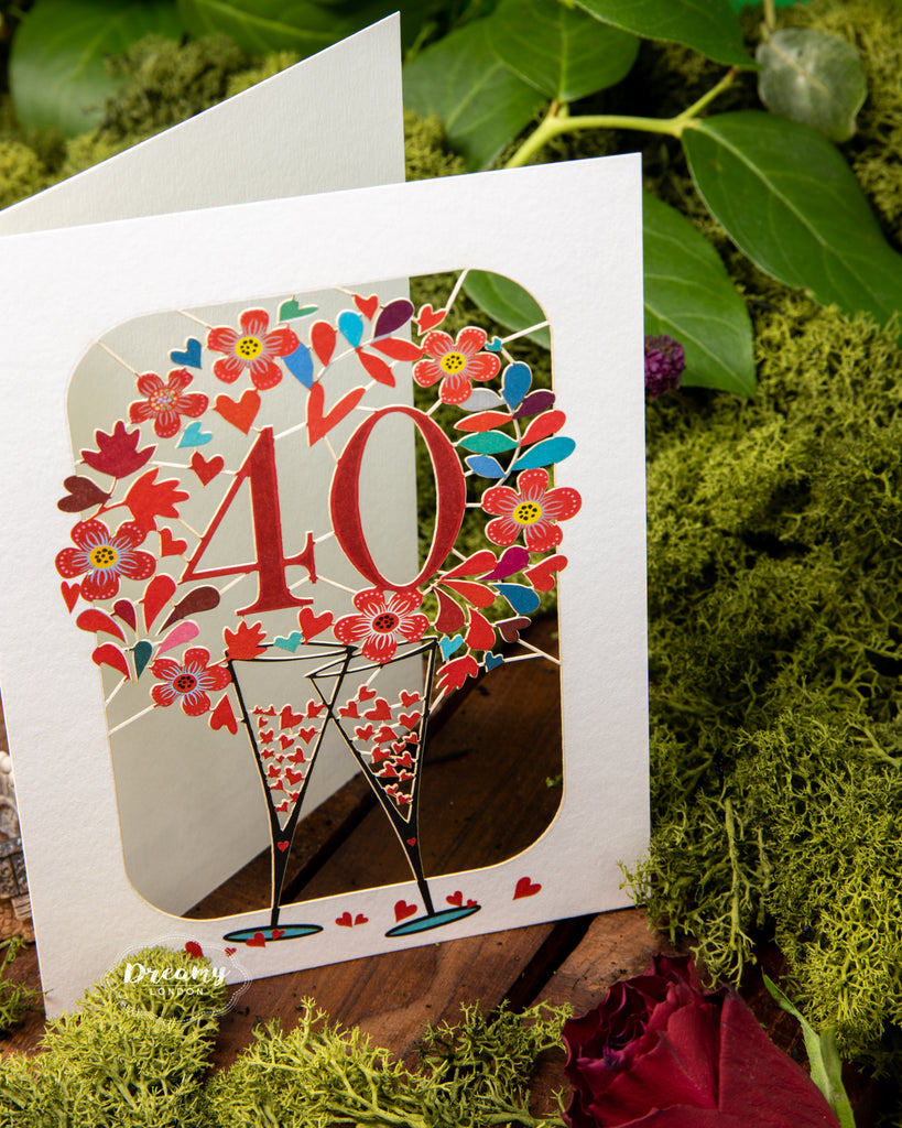 40th Wedding Anniversary Card - Ruby Wedding Anniversary Card that features clanking champagne glasses surrounded with hearts | Dreamy London