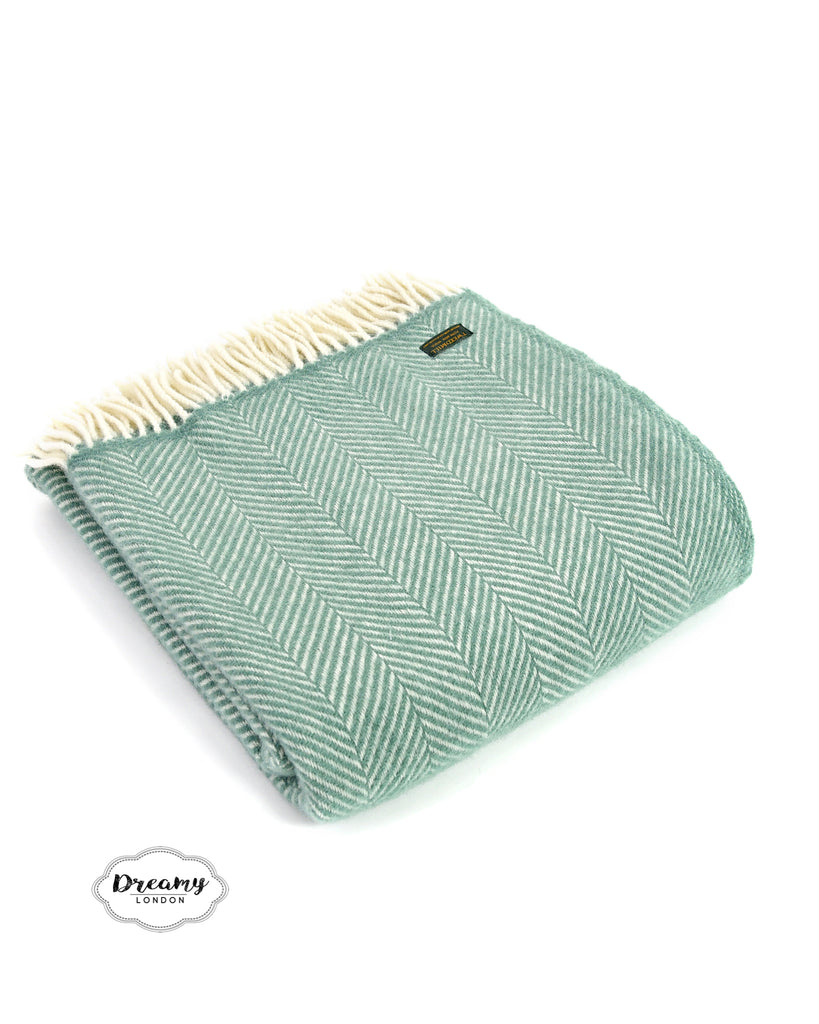 folded  wool blanket in teal green with tassels - dreamylondon